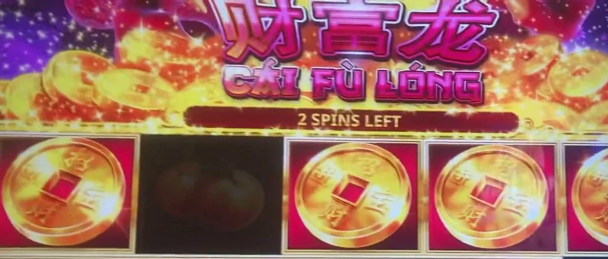 Gold coins locked across the reels under the '2 SPINS LEFT' counter. That banner above the reels — and the count of locked coins — is the entire read before you sit.