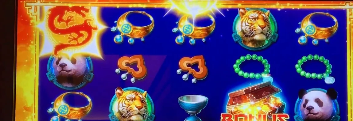 The red dragon symbol glowing on reel one — this is the target a descending sphere has to settle on. When a sphere lands on a dragon, every position around it flips to wild.