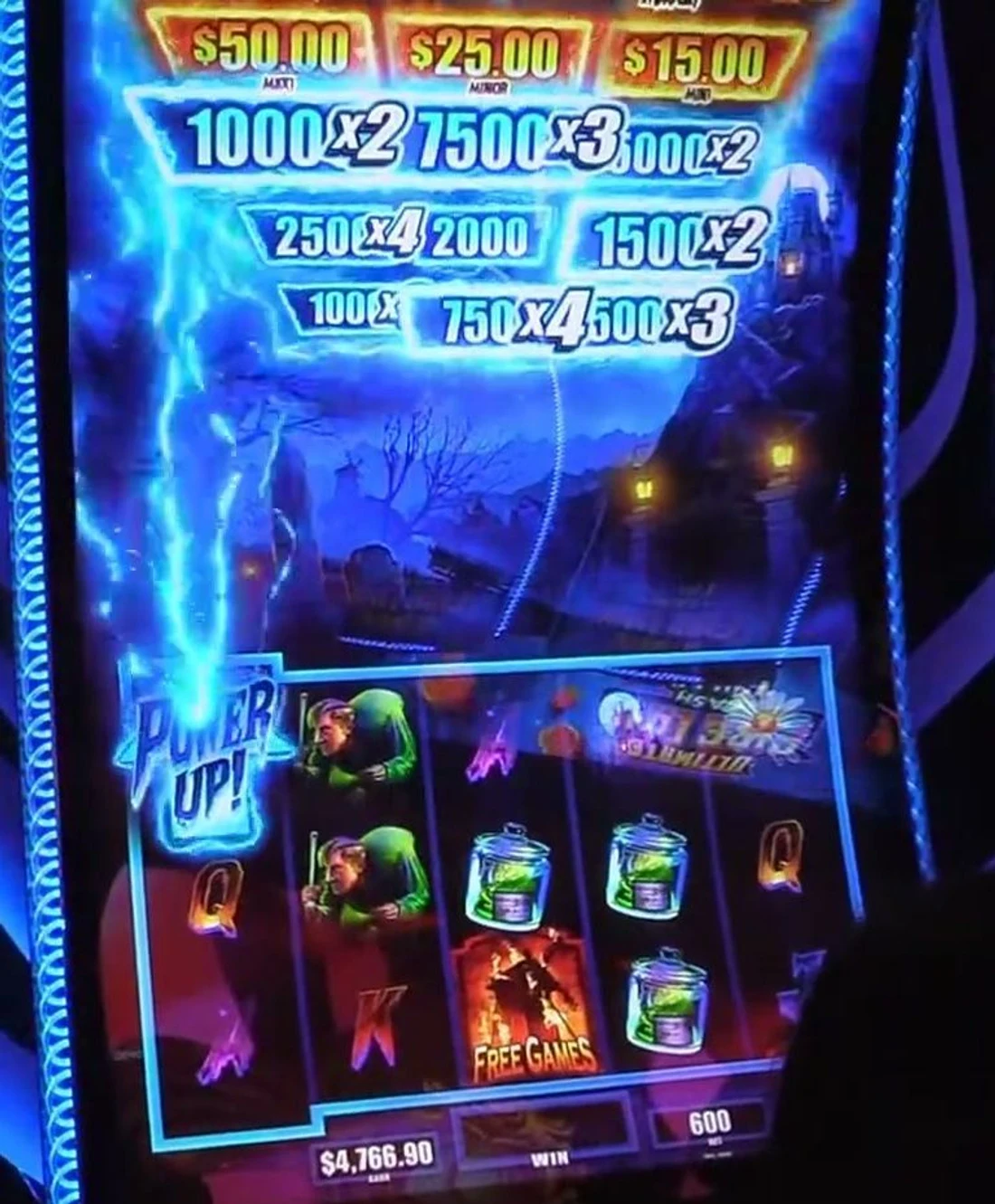 The prize array above the reels: six-plus blue Credit Prizes carrying live multipliers (1000 x2, 7500 x3, 250 x4, 750 x4, 500 x3) with a Power Up firing and Free Games on the reels — a real 12x+ entry.