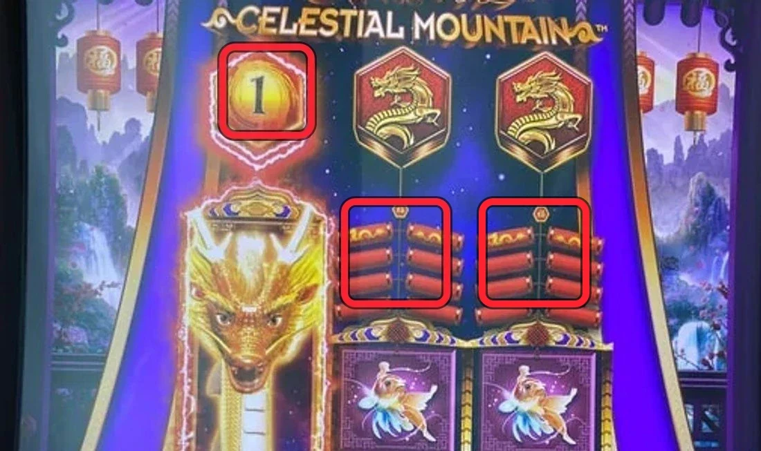 The play state on the glass. The left reel is already cleared and active — the glowing dragon column with a “1” in the hexagon above it (active spins left). The two firecracker reels are nearly empty: ringed in red, just a short remaining set hangs on each below a long blown-out chain. Total the sets left on those two reels — 3 or fewer is your play.