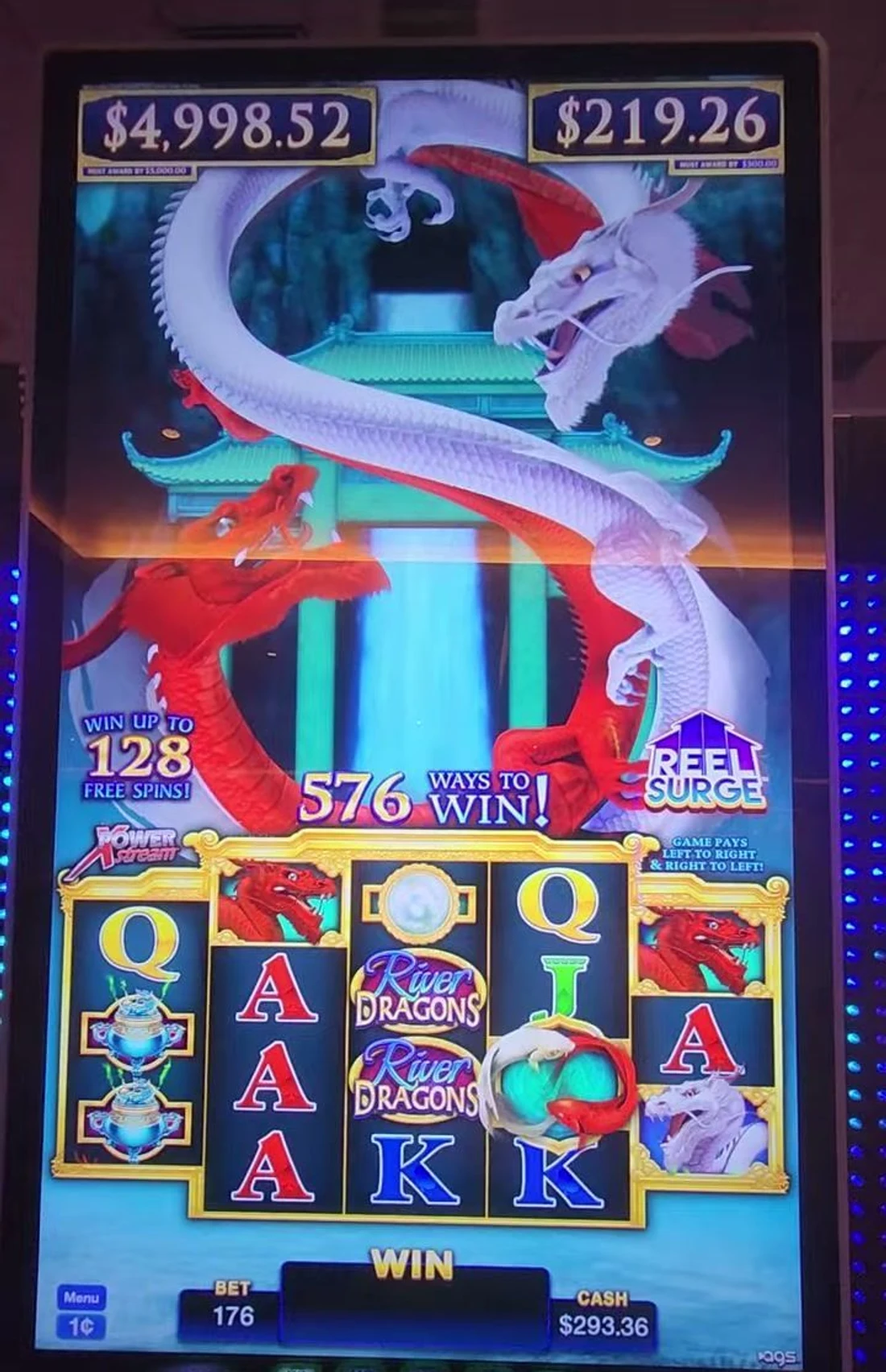 The two must-hit-by counters above the reels, ringed in red: $4,732.25 / must award by $5,000 on the left, $466.83 / must award by $500 on the right. Both readings are still climbing toward the play lines ($4,920 and $486) — that is exactly what you are watching for. Those two numbers are the whole read.
